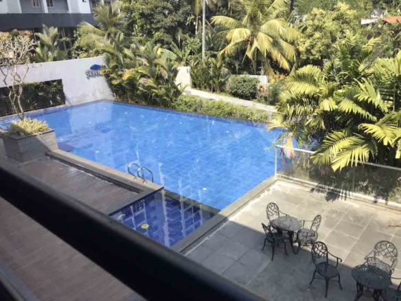 Luxury swimming pool and outdoor lounge area at Skyline The Edge, a premium 3-bedroom flat for sale in Thiruvalla.