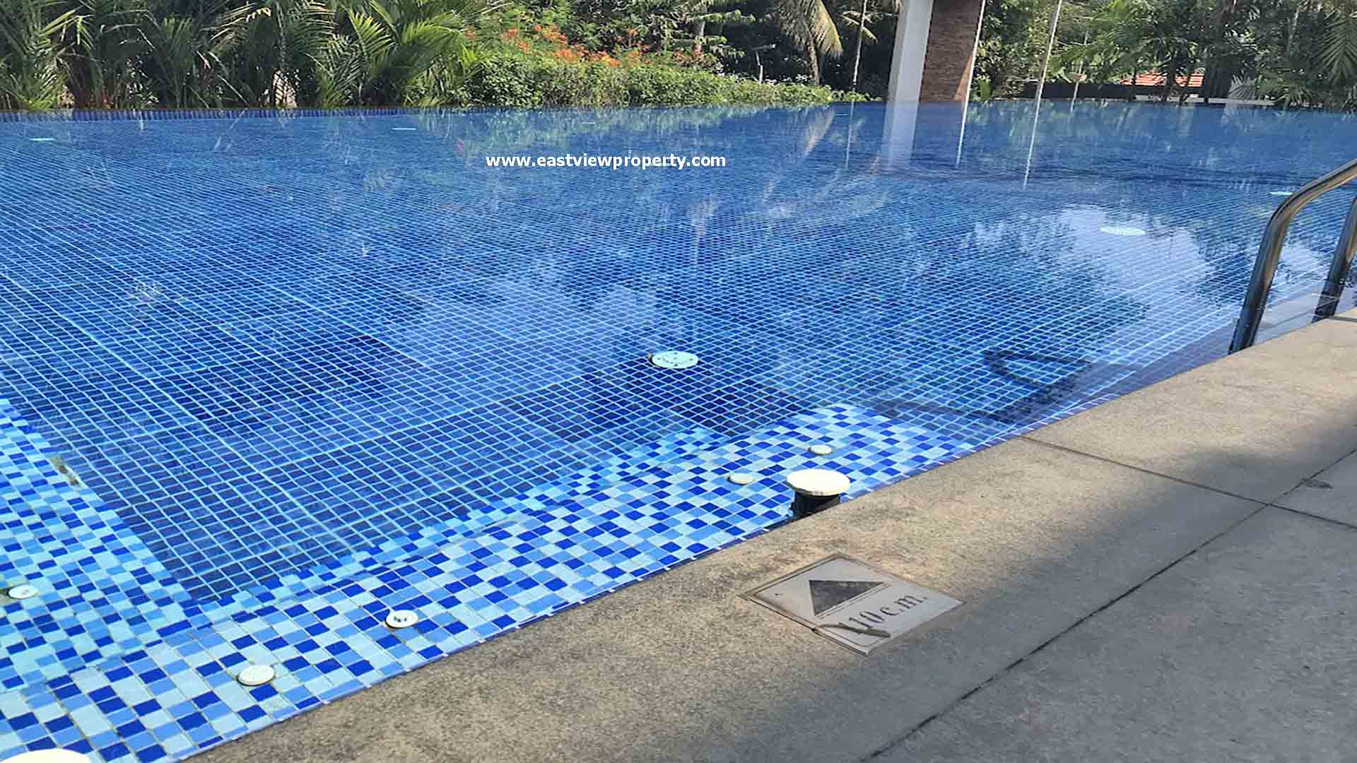Infinity-edge swimming pool at Skyline The Edge luxury apartments in Thiruvalla, Kerala.