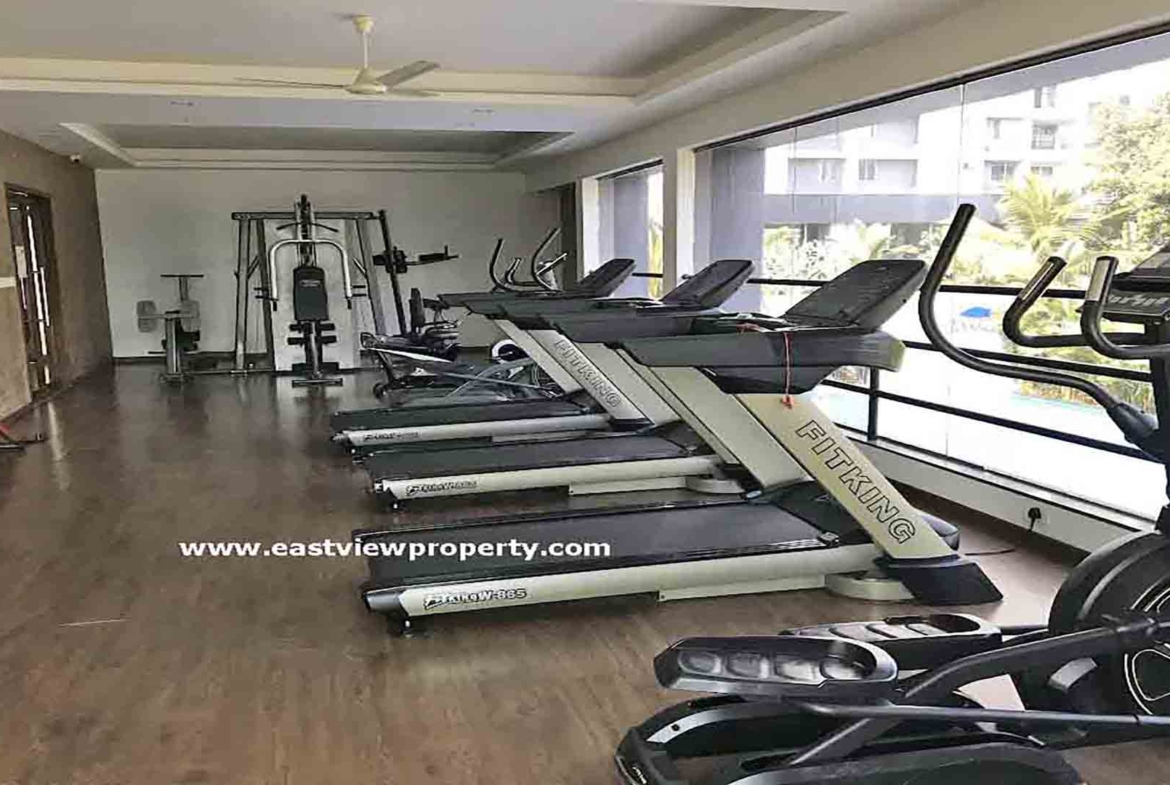 Modern fitness centre and gym for residents at Skyline The Edge luxury apartments in Thiruvalla.