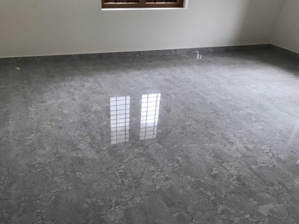 Spacious bedroom interior with premium grey marble-finish floor tiles in a new 2-storey house for sale in Pullad, Thiruvalla.