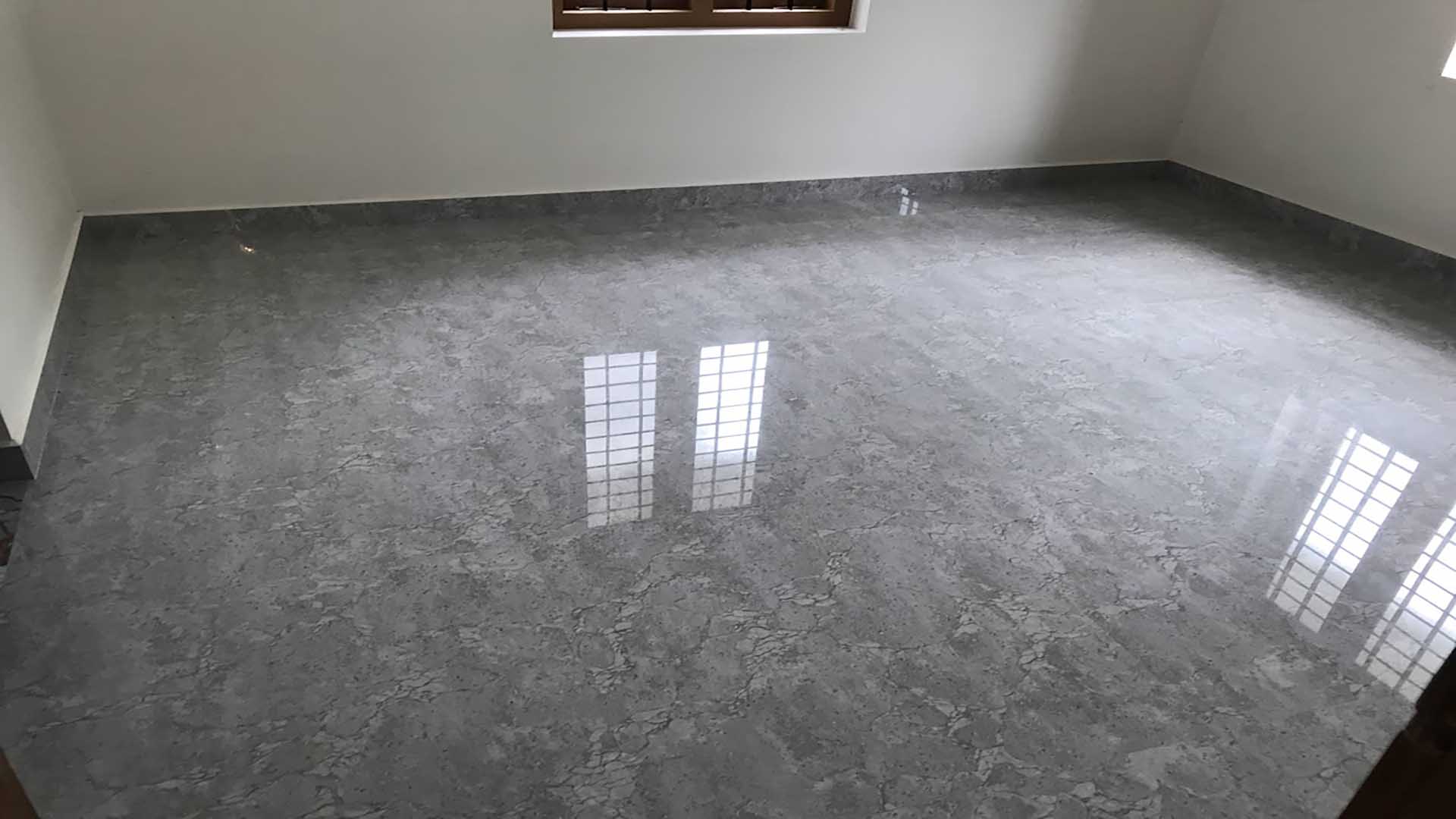 Spacious bedroom interior with premium grey marble-finish floor tiles in a new 2-storey house for sale in Pullad, Thiruvalla.