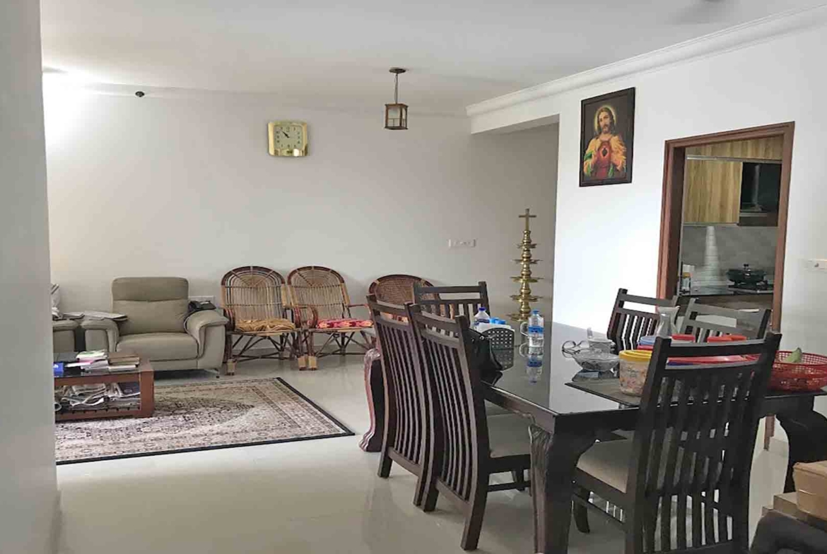 Furnished dining room in a 3BHK luxury flat at Skyline The Edge, Thiruvalla, featuring a dark wood dining set.