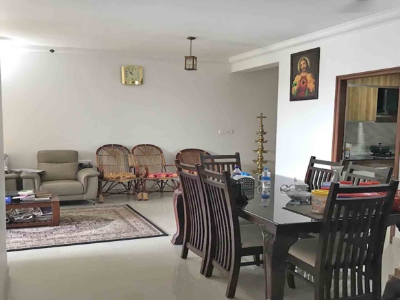 Furnished dining room in a 3BHK luxury flat at Skyline The Edge, Thiruvalla, featuring a dark wood dining set.