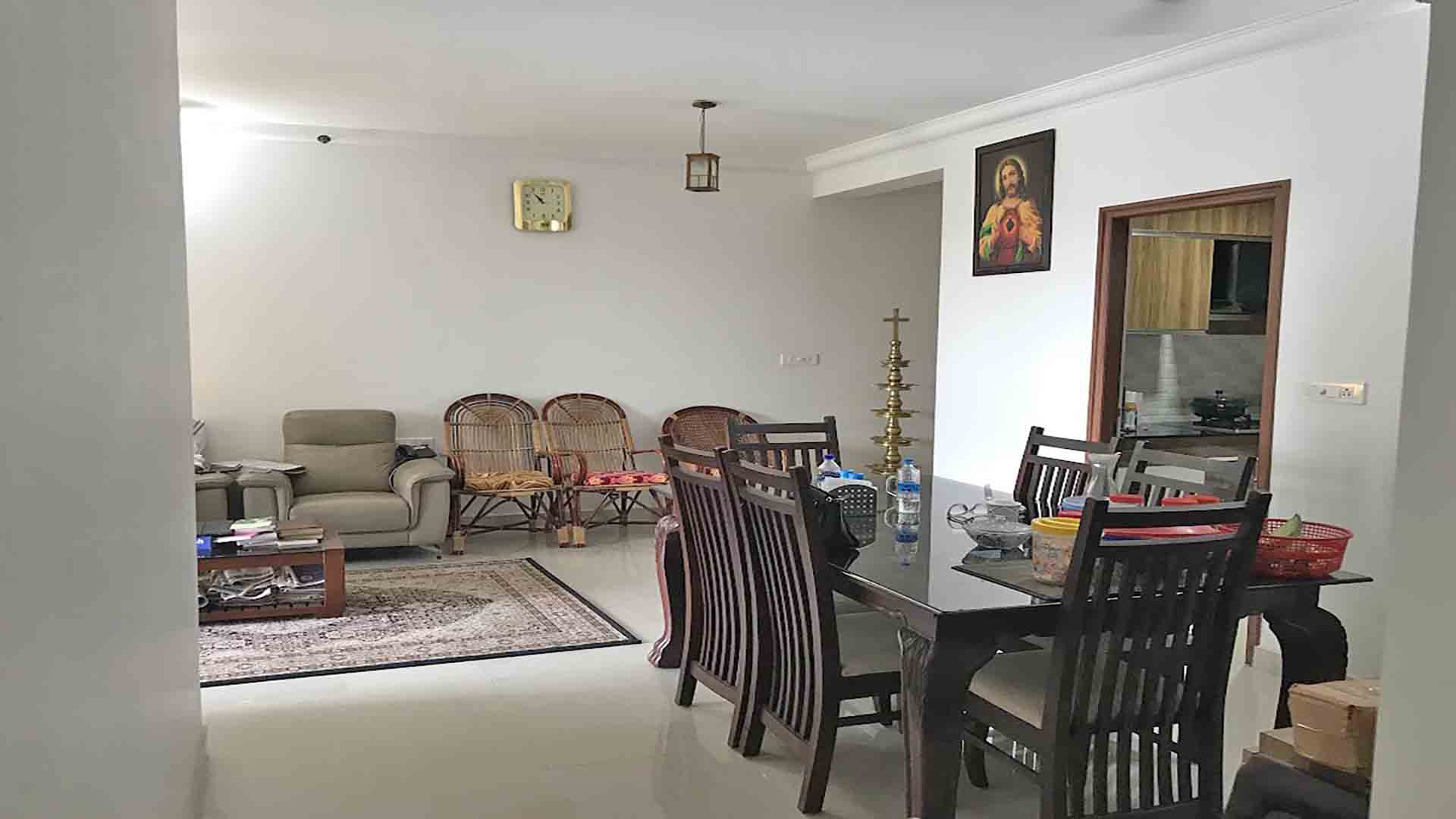 Furnished dining room in a 3BHK luxury flat at Skyline The Edge, Thiruvalla, featuring a dark wood dining set.