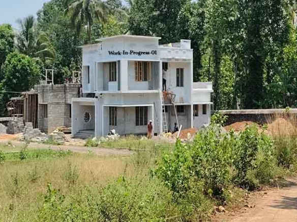 Wide view of a new 4 BHK house under construction in Thiruvalla, Kerala, showing the road access and 8-cent plot near IPC Hebron.