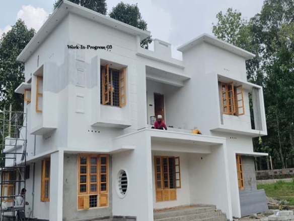 Exterior plastering and window installation phase of a new 4-bedroom two-storey house for sale in Thiruvalla.