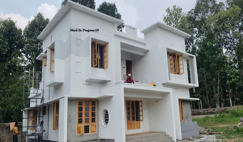 Exterior plastering and window installation phase of a new 4-bedroom two-storey house for sale in Thiruvalla.