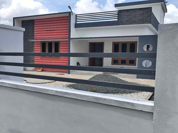 A single-storey 2-bedroom villa in Chengannur, Kerala, with a top grilled boundary wall and gate. Priced ₹ 50 Lakh (negotiable).