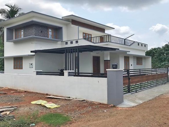 Side view of a two-storey 3 BHK house with a boundary wall on 7 cents of land in Eraviperoor (Eravery), Thiruvalla, for sale