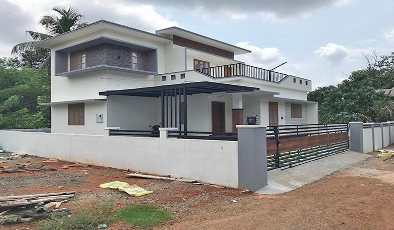 Side view of a two-storey 3 BHK house with a boundary wall on 7 cents of land in Eraviperoor (Eravery), Thiruvalla, for sale