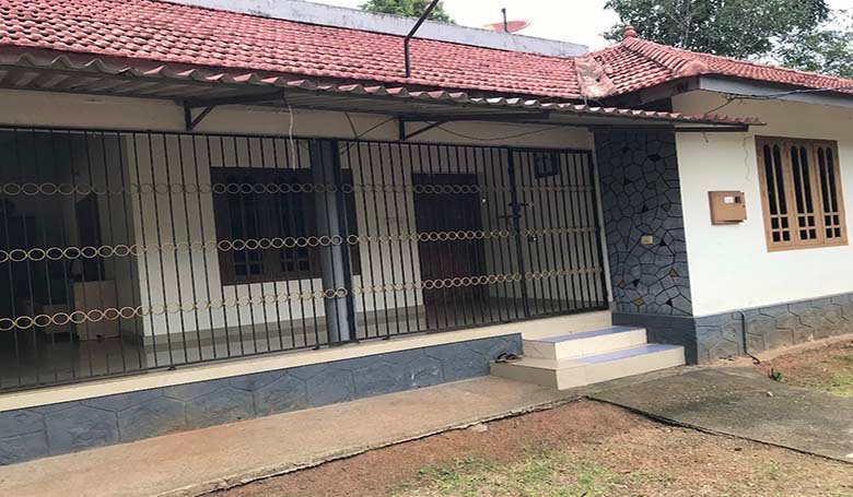 Single storey 2 BHK house with tiled roof and secured veranda with grills in Kareelamukk, Thiruvalla