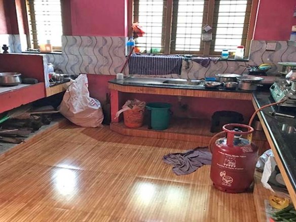 Modern tiled kitchen interior in a 2 BHK house in Kareelamukk, Thiruvalla