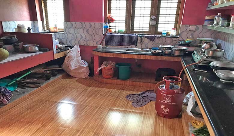 Modern tiled kitchen interior in a 2 BHK house in Kareelamukk, Thiruvalla
