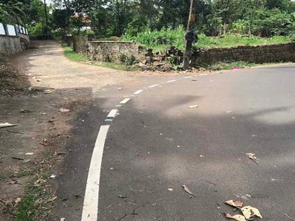 Wide tarred main road Vittil Junction Road in Chengannur, Kerala, close to the land with access.