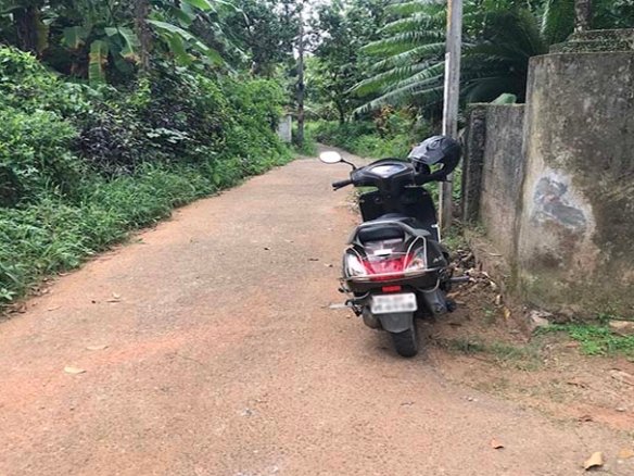 Motor scooter parked along the tarred sub-road in front of the land and to the Vittil Junction Road Chengannur.