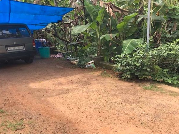 Four-wheeler vehicle parked on the access road leading to the 70 cents land plot for sale in Chengannur Kerala.