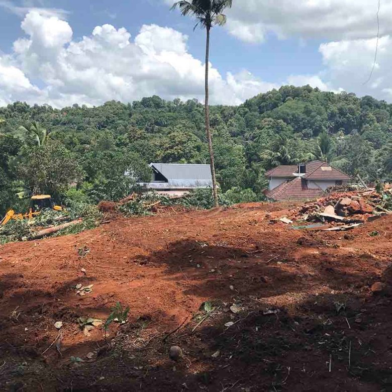 Elevated 60 cent land for sale in Puramattom showing surrounding green hills and houses