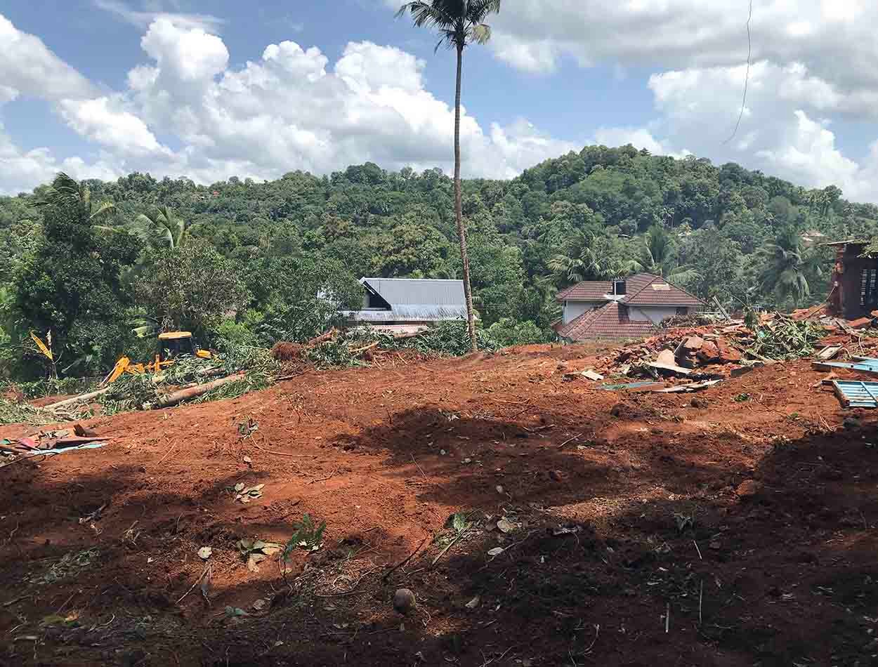 Elevated 60 cent land for sale in Puramattom showing surrounding green hills and houses