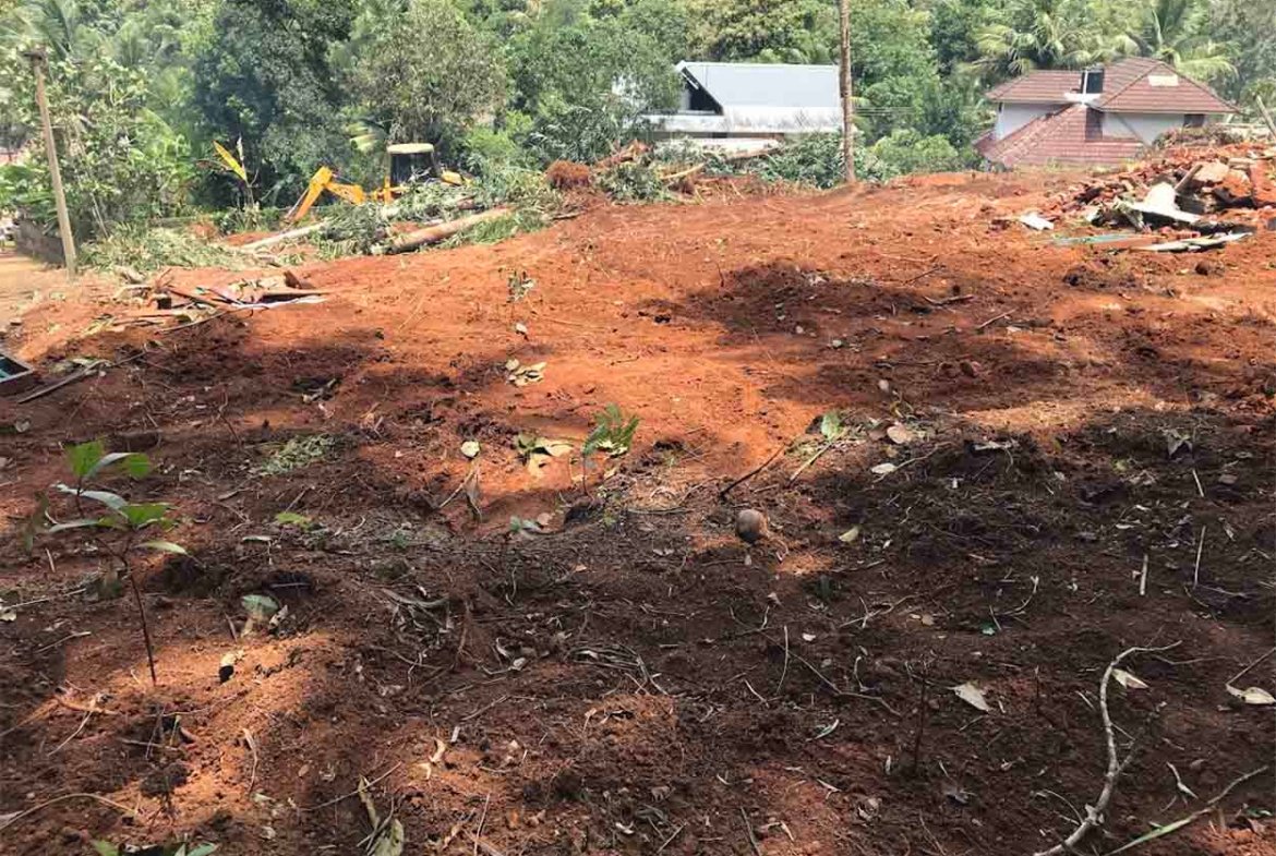 Wide view of elevated land cleared for development near Komattu Junction along Kumbanad Puramattom road