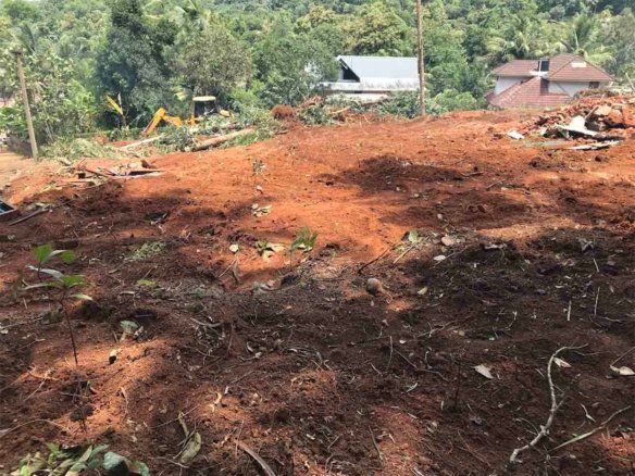 Wide view of elevated land cleared for development near Komattu Junction along Kumbanad Puramattom road