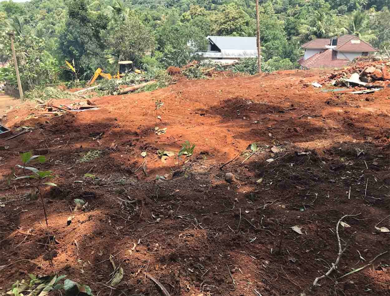 Wide view of elevated land cleared for development near Komattu Junction along Kumbanad Puramattom road