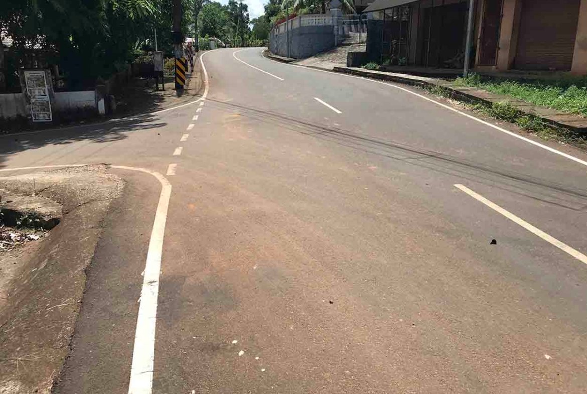Paved main road frontage leading to land plot near Komattu Junction on Kumbanad Puramattom route