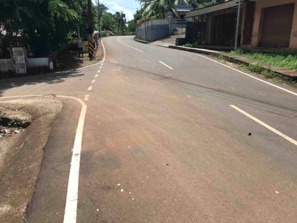 Paved main road frontage leading to land plot near Komattu Junction on Kumbanad Puramattom route