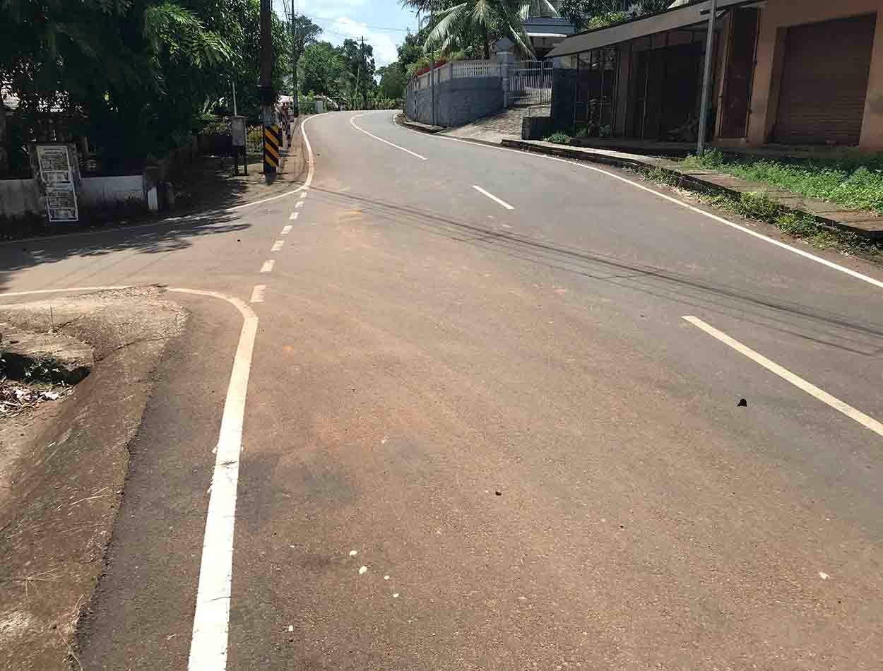 Paved main road frontage leading to land plot near Komattu Junction on Kumbanad Puramattom route