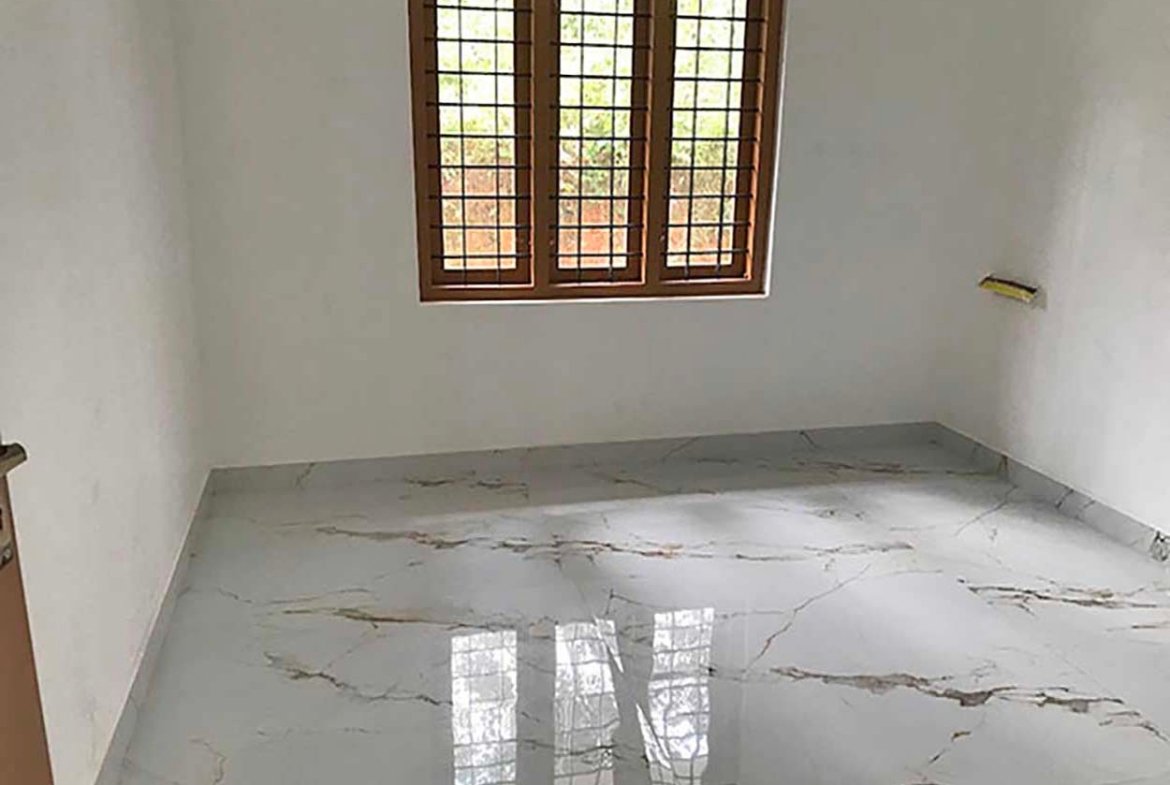 Well-lit master bedroom featuring a wooden window with safety grills and polished marble floor tiles