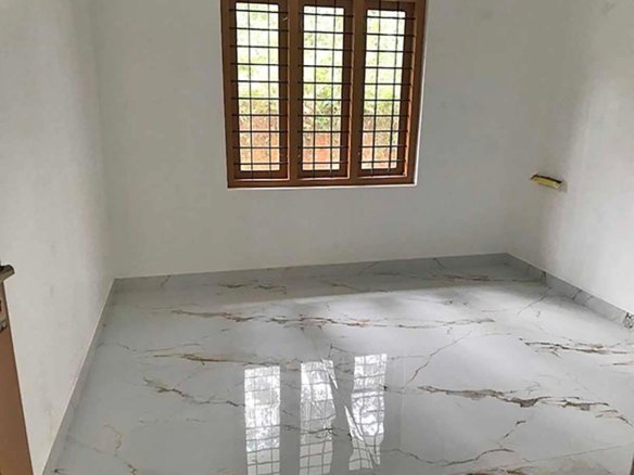 Well-lit master bedroom featuring a wooden window with safety grills and polished marble floor tiles